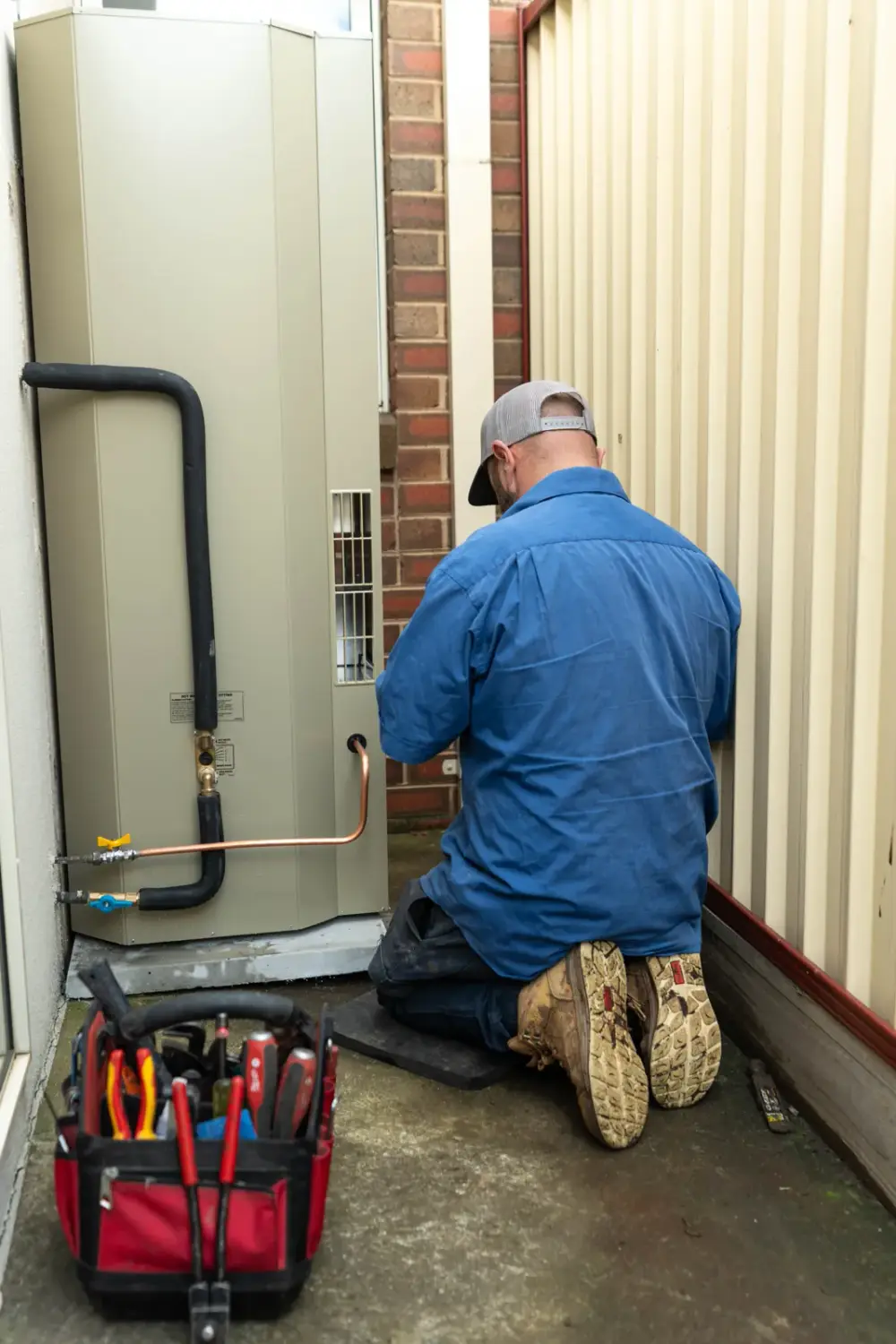 Heat pump hot water system being installed at a Hobsons Bay home